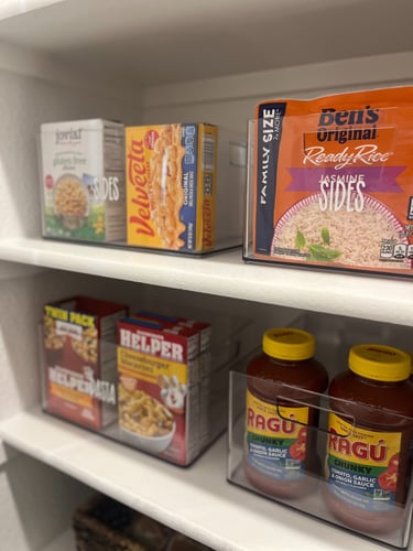 Custom pantry systems with labeled acrylic containers designed for long term home organization