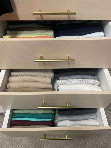 Drawer organization with precisely folded clothing creating a clean and easy to maintain system