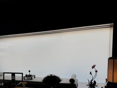 Minimalist meditation room featuring a steel tongue drum and floral decor against a large frosted window.