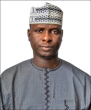 Portrait of a man wearing a traditional West African kufi hat and embroidered dashiki shirt.