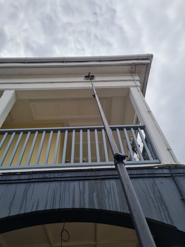 Cleaning fascia with window fed pole