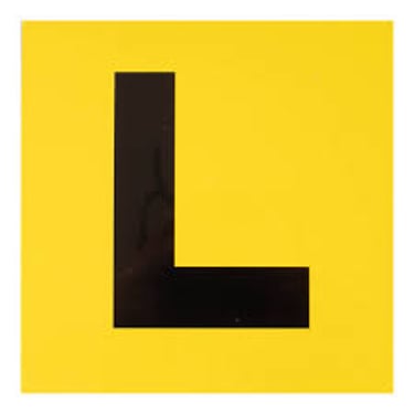 A square yellow learner driver plate featuring a large black letter L for student drivers.