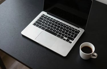 A minimalist, top-down photograph of a premium black desk with a high-end silver laptop and a single espresso cup, Global / International style.