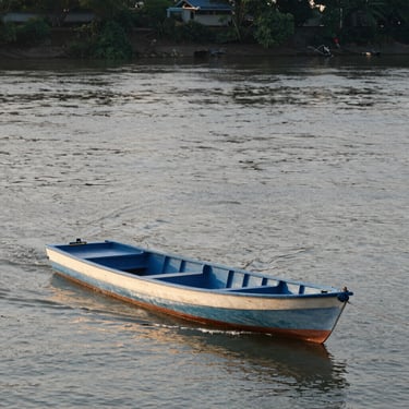 A cozy workspace with soft peach tones, a laptop open to a blog post, surrounded by warm fairy lights and a cup of tea.