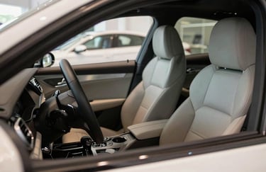 Interior of a premium car showing leather seats and steering wheel with meticulous detail, soft natural light, conveying luxury and professional care, Southern European / Spanish dealership.
