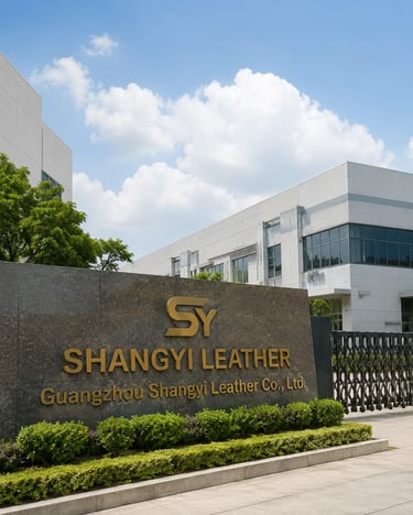 Guangzhou Shangyi Leather Co., Ltd. factory exterior with gold signage on a stone wall.