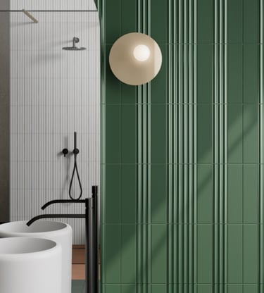 Modern bathroom featuring forest green fluted wall tiles and a round designer wall sconce.