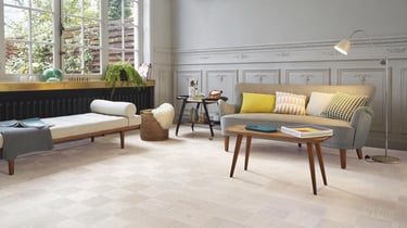 Modern living room with light oak parquet flooring, mid-century furniture, and grey wainscoting.
