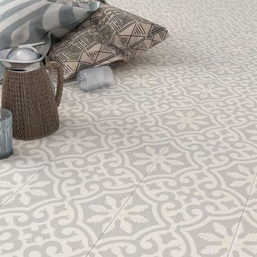 Elegant grey and white patterned ceramic floor tiles with a vintage fleur-de-lis inspired design.