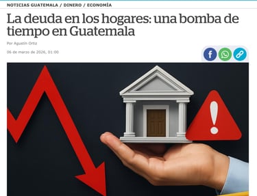 Hand holding a model house next to a red warning sign and a falling economic arrow.