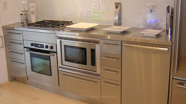 Integrated stainless steel kitchen cabinets with built-in appliances and modern design.