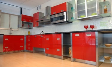 Cabinets with powder-coated red fronts and stainless steel interiors