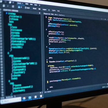 Close-up of a computer monitor displaying complex software code with vibrant neon cyan and light gray syntax highlighting, professional studio setting.