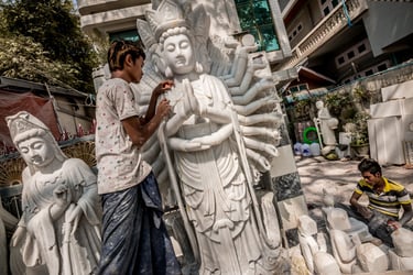 A marble artist works on a Buddhist sculpture in Myanmar's northern town of Mandalay.