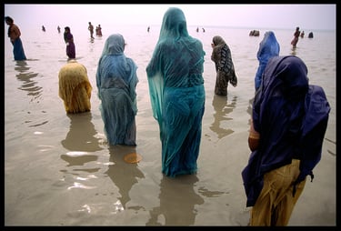 Spiritual pilgrims pray at the place where the Ganges River empties into the ocean.