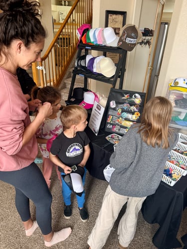adult female and kids looking at patches