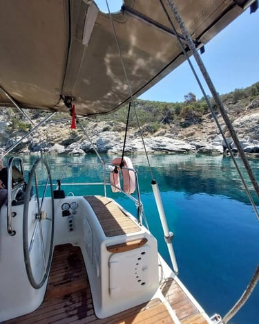 Sail Boat Christina anchored in a secluded turquoise bay during a private yacht cruise in Halkidiki