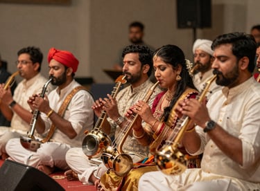 A group of musicians performing traditional and contemporary instruments at a South Asian / Indian celebration.