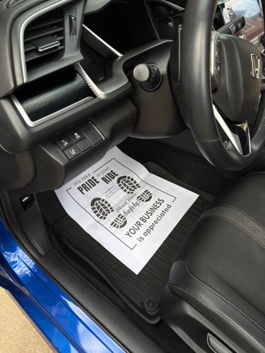Disposable paper floor mat used during car detailing service in Logan Ohio to protect interior