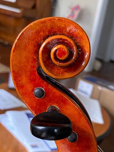 Jim Clinton Violin, 2025 bass side of scroll with red over golden varnish