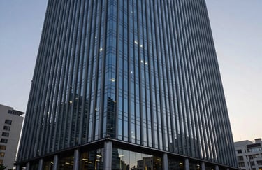 A sleek, modern corporate building exterior in a major South Asian / Indian city during dusk, with professional lighting, capturing a sense of reliability and established presence.