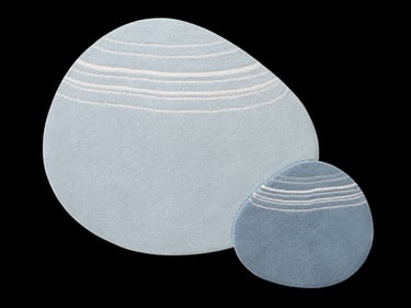 Modern pebble-shaped blue rugs with white wave patterns for minimalist home decor.