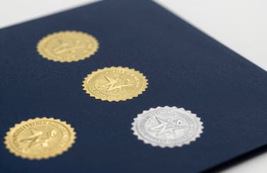 Close-up of official aviation certification documents with gold and silver embossed seals on a clean, professional dark surface (#0A1C2B). High trust and authoritative feel.