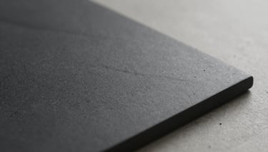 A professional mood board with samples of #2C3333 dark stone, #597E52 forest green accents, and brass hardware in a bright studio.