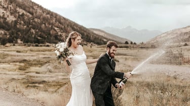 Weddings - happy goofy couple in front of mountain view