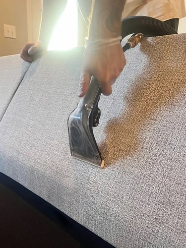 Hand tool cleaning couch fabric in Denver