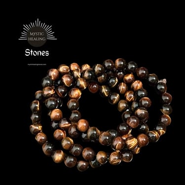 Polished red tiger eye crystal beaded bracelets for healing and protection on a black background.