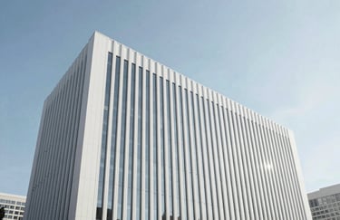 Modern architecture of a sleek business center in a North American / US city, emphasizing clean lines and pure white surfaces under a clear, bright sky.