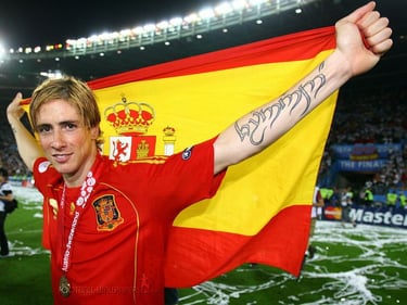 Fernando Torres celebrating Spain victory at Euro 2008 holding the Spanish flag and showing his tattoo.