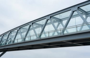 Architectural shot of a modern glass and steel bridge in a tech park, clean minimalist lines in steel blue and mist grey.