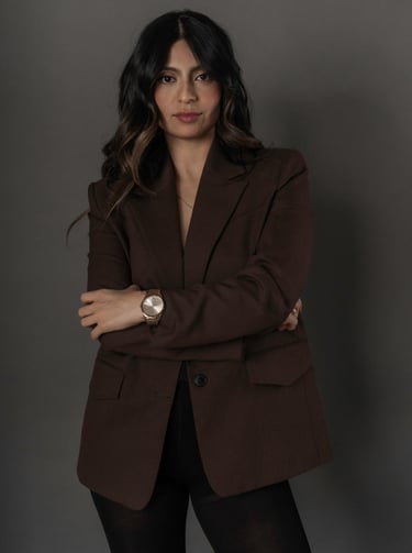 Professional studio of woman wearing a blazer, photographed with soft lighting for a modern business