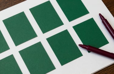 Top-down view of a marketing strategy board in a North American / US office, featuring matte forest green color swatches and deep ripe crimson markers on a crisp parchment surface.