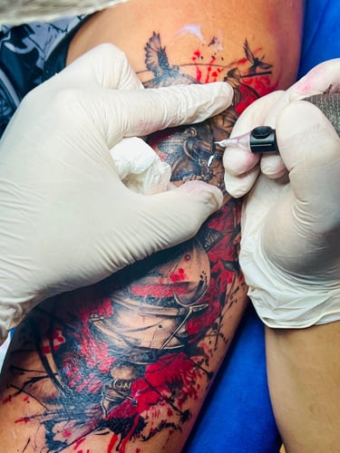 Tattoo artist in Hurghada doing fine line tattoo on client’s arm”