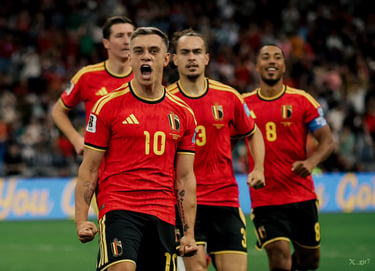 Leandro Trossard and Belgium national football team players celebrate a goal on the pitch.