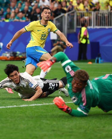 Gabriel Martinelli of Brazil attacks the goal against Japan's goalkeeper and defender in a soccer match.