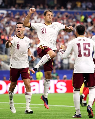 Spain national football team players Mikel Oyarzabal and teammates celebrating a goal during a match.