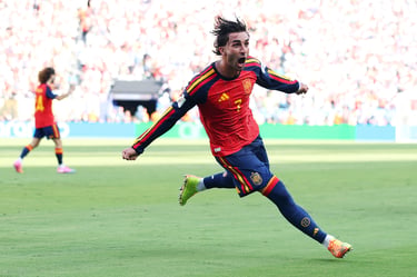 Spain national football team player Ferran Torres celebrating a goal on the pitch.