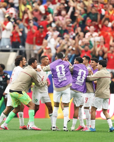 Morocco national team players celebrate a goal during a FIFA World Cup 2026 qualifier match.