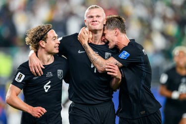 Erling Haaland celebrates a goal with teammates for Norway's national football team during a match.