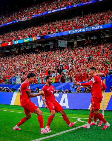 Portuguese soccer players celebrate a goal in front of a massive crowd during a FIFA World Cup 2026 match.