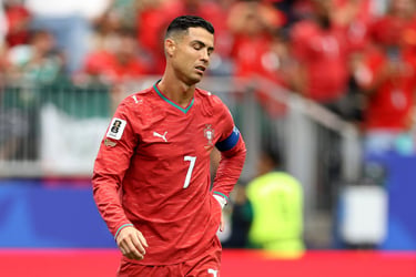 Cristiano Ronaldo looking disappointed in his Portugal national team jersey during a football match.