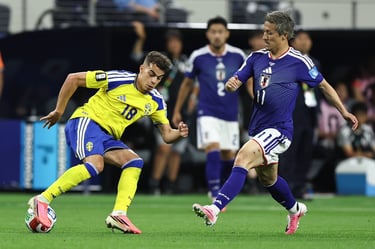 Swedish and Japanese professional soccer players compete for ball possession during an international football match.