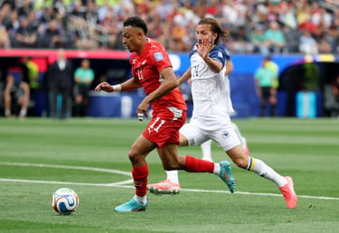 Professional soccer players in red and white jerseys compete for ball possession during an intense stadium match.