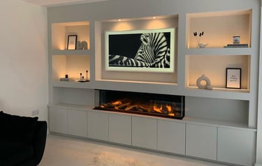 Custom media wall installation with shelving, built-in storage, and ambient lighting