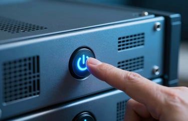 A close-up of a finger pressing a glowing power button on a piece of high-end, steel blue server equipment.