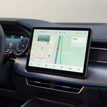 Close-up of a high-tech car dashboard displaying navigation and comfort controls. Modern and clean design with steel blue accents. South American / Brazilian context.